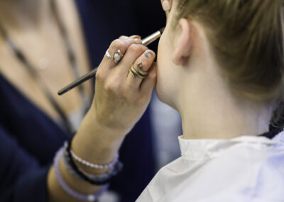Image of a student putting eyeliner